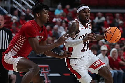 Dec 7, 2022; Lubbock, Texas, USA; Texas Tech Red Raiders guard De Vion Harmon (23) dribbles the ball against Nicholls Colonels forward Mekhi Collins (13) in the first half at United Supermarkets Arena. Mandatory Credit: Michael C. Johnson-USA TODAY Sports