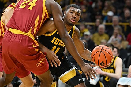 Dec 8, 2022; Iowa City, Iowa, USA; Iowa Hawkeyes guard Tony Perkins (11) controls the ball as Iowa State Cyclones forward Hason Ward (24) defends during the first half at Carver-Hawkeye Arena. Mandatory Credit: Jeffrey Becker-USA TODAY Sports