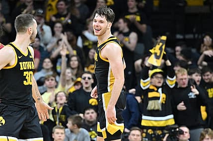 Dec 8, 2022; Iowa City, Iowa, USA; Iowa Hawkeyes forward Filip Rebraca (0) reacts with guard Connor McCaffery (30) during the second half against the Iowa State Cyclones at Carver-Hawkeye Arena. Mandatory Credit: Jeffrey Becker-USA TODAY Sports