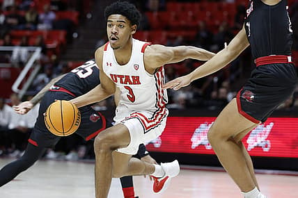 Dec 8, 2022; Salt Lake City, Utah, USA;  Utah Utes forward Bostyn Holt (3) drives past Jacksonville State Gamecocks guard Travis Roberts (11) in the second half at Jon M. Huntsman Center. Mandatory Credit: Jeffrey Swinger-USA TODAY Sports