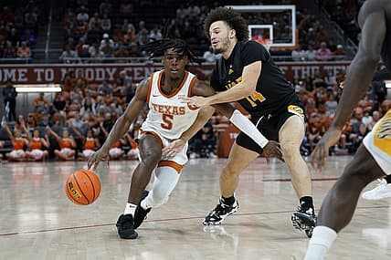 Dec 10, 2022; Austin, Texas, USA; Texas Longhorns guard Marcus Carr (5) drives to the basket Arkansas Pine-Bluff Golden Lions guard Brahm Harris (14) during the first half at Moody Center. Mandatory Credit: Scott Wachter-USA TODAY Sports