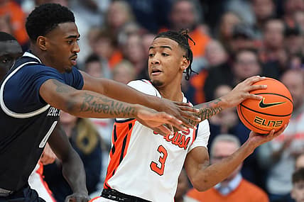 Dec 10, 2022; Syracuse, New York, USA; Syracuse Orange guard Judah Mintz (3) controls the ball as Georgetown Hoyas guard Brandon Murray (0) defends during the first half at the JMA Wireless Dome. Mandatory Credit: Rich Barnes-USA TODAY Sports