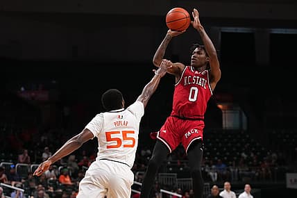 Dec 10, 2022; Coral Gables, Florida, USA; North Carolina State Wolfpack guard Terquavion Smith (0) shoots over Miami Hurricanes guard Wooga Poplar (55) during the first half at Watsco Center. Mandatory Credit: Jasen Vinlove-USA TODAY Sports