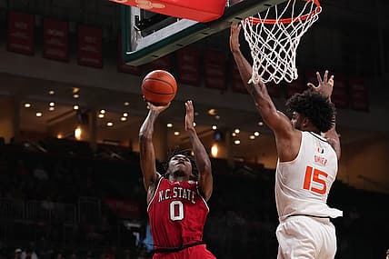Dec 10, 2022; Coral Gables, Florida, USA; North Carolina State Wolfpack guard Terquavion Smith (0) shoots the ball in front of Miami Hurricanes forward Norchad Omier (15) during the first half at Watsco Center. Mandatory Credit: Jasen Vinlove-USA TODAY Sports