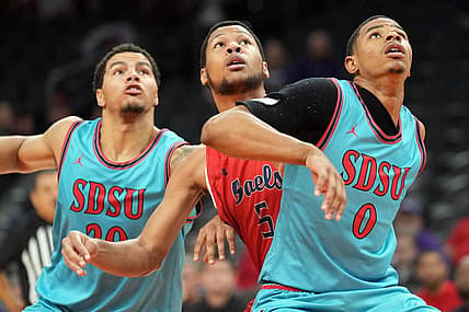Dec 10, 2022; Phoenix, Arizona, USA; San Diego State Aztecs guard Matt Bradley (20) and San Diego State Aztecs forward Keshad Johnson (0) box out St. Mary's Gaels forward Josh Jefferson (5) during the first half at Footprint Center. Mandatory Credit: Joe Camporeale-USA TODAY Sports