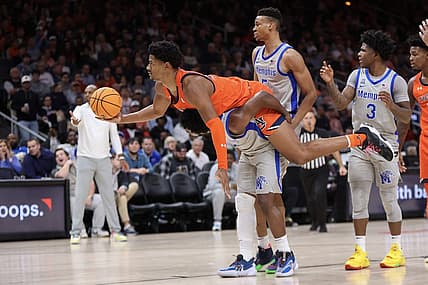 Dec 10, 2022; Atlanta, Georgia, USA; Auburn Tigers center Dylan Cardwell (44) lays on the back of Memphis Tigers guard Alex Lomax (2) in the first half at State Farm Arena. Mandatory Credit: Brett Davis-USA TODAY Sports