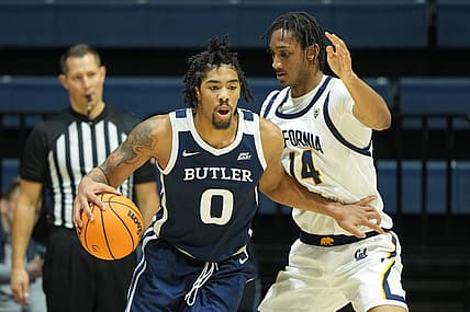 Dec 10, 2022; Berkeley, California, USA; Butler Bulldogs forward D.J. Hughes (0) dribbles against California Golden Bears forward Grant Newell (14) during the second half at Haas Pavilion. Mandatory Credit: Darren Yamashita-USA TODAY Sports