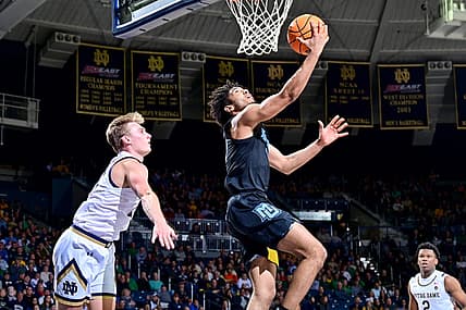 Dec 11, 2022; South Bend, Indiana, USA; Marquette Golden Eagles guard Stevie Mitchell (4) goes up for a shot as Notre Dame Fighting Irish guard Dane Goodwin (23) defends in the second half at the Purcell Pavilion. Mandatory Credit: Matt Cashore-USA TODAY Sports
