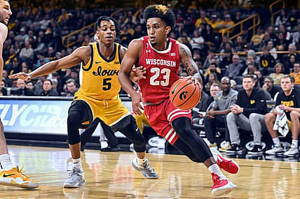 Dec 11, 2022; Iowa City, Iowa, USA; Wisconsin Badgers guard Chucky Hepburn (23) goes to the basket as Iowa Hawkeyes guard Dasonte Bowen (5) defends during the first half at Carver-Hawkeye Arena. Mandatory Credit: Jeffrey Becker-USA TODAY Sports