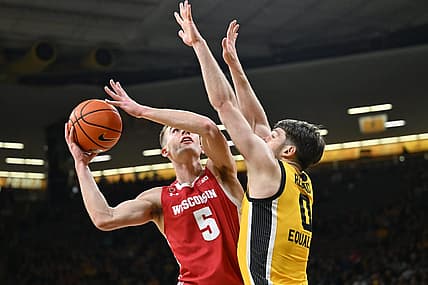 Dec 11, 2022; Iowa City, Iowa, USA; Wisconsin Badgers forward Tyler Wahl (5) shoots the ball as Iowa Hawkeyes forward Filip Rebraca (0) defends during the first half at Carver-Hawkeye Arena. Mandatory Credit: Jeffrey Becker-USA TODAY Sports