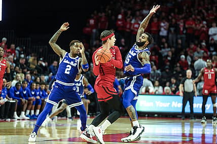 Dec 11, 2022; Piscataway, New Jersey, USA;  Rutgers Scarlet Knights guard Paul Mulcahy (4) tries to pass over Seton Hall Pirates guard Jamir Harris (15) in the first half at Jersey Mike's Arena. Mandatory Credit: Wendell Cruz-USA TODAY Sports