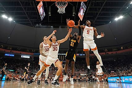 Dec 10, 2022; Austin, Texas, USA; Texas Longhorns guard Marcus Carr (5) and forward Brock Cunningham (30) along with Arkansas Pine-Bluff Golden Lions guard Shaun Doss Jr. (21) reach for a rebound during the second half at Moody Center. Mandatory Credit: Scott Wachter-USA TODAY Sports