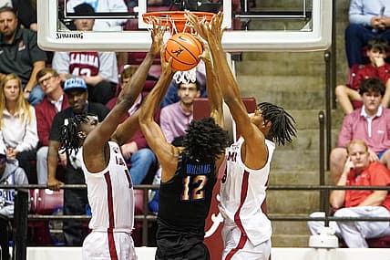 Dec 13, 2022; Tuscaloosa, Alabama, USA; Memphis Tigers forward DeAndre Williams (12) goes to the basket against Alabama Crimson Tide defenders during the second half at Coleman Coliseum. Mandatory Credit: Marvin Gentry-USA TODAY Sports