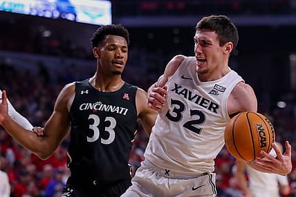 Dec 10, 2022; Cincinnati, Ohio, USA; Xavier Musketeers forward Zach Freemantle (32) against Cincinnati Bearcats forward Ody Oguama (33) in the first half at Fifth Third Arena. Mandatory Credit: Katie Stratman-USA TODAY Sports