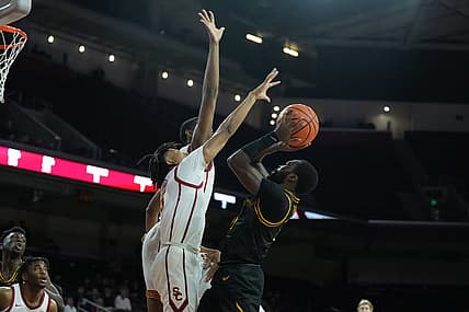 Dec 14, 2022; Los Angeles, California, USA; Long Beach State Beach guard Joel Murray (11) shoots against Southern California Trojans guard Boogie Ellis (5) and forward Joshua Morgan (24) in the first half at Galen Center. Mandatory Credit: Kirby Lee-USA TODAY Sports