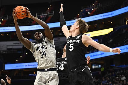 Dec 16, 2022; Washington, District of Columbia, USA; Georgetown Hoyas center Qudus Wahab (34) shoots over Xavier Musketeers guard Adam Kunkel (5) during the first half at Capital One Arena. Mandatory Credit: Brad Mills-USA TODAY Sports