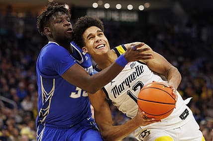 Dec 16, 2022; Milwaukee, Wisconsin, USA;  Marquette Golden Eagles forward Oso Ighodaro (13) looks to shoot against Creighton Bluejays center Fredrick King (33) during the second half at Fiserv Forum. Mandatory Credit: Jeff Hanisch-USA TODAY Sports