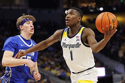Dec 16, 2022; Milwaukee, Wisconsin, USA;  Marquette Golden Eagles guard Kam Jones (1) drives for a shot around Creighton Bluejays guard Baylor Scheierman (55) during the second half at Fiserv Forum. Mandatory Credit: Jeff Hanisch-USA TODAY Sports