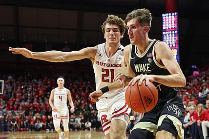 Dec 17, 2022; Piscataway, New Jersey, USA; Wake Forest Demon Deacons forward Andrew Carr (11) dribbles against Rutgers Scarlet Knights forward Dean Reiber (21) during the first half at Jersey Mike's Arena. Mandatory Credit: Vincent Carchietta-USA TODAY Sports