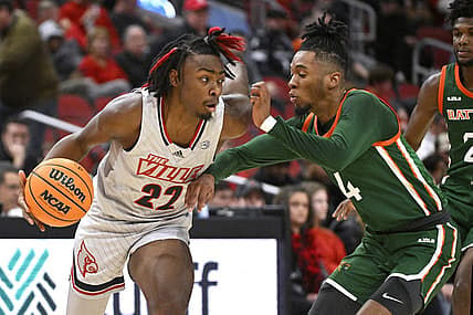 Dec 17, 2022; Louisville, Kentucky, USA;  Louisville Cardinals forward Kamari Lands (22) dribbles against Florida A&M Rattlers guard Hantz Louis-Jeune (4) during the first half at KFC Yum! Center. Mandatory Credit: Jamie Rhodes-USA TODAY Sports
