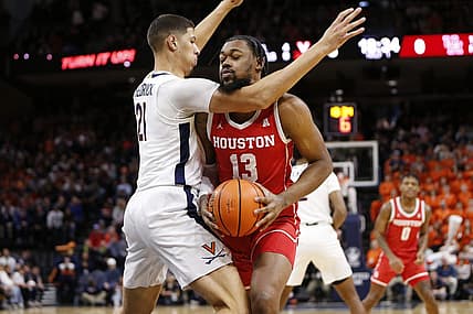 Dec 17, 2022; Charlottesville, Virginia, USA; Houston Cougars forward J'Wan Roberts (13) attempts to shoot the ball as Virginia Cavaliers forward Kadin Shedrick (21) defends during the first half at John Paul Jones Arena. Mandatory Credit: Amber Searls-USA TODAY Sports