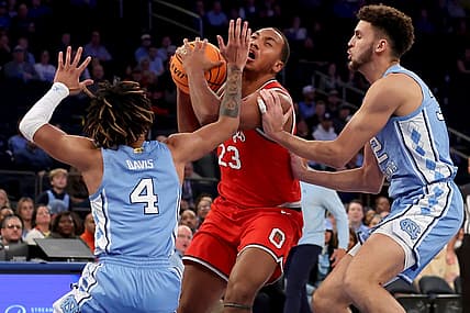 Dec 17, 2022; New York, New York, USA; Ohio State Buckeyes forward Zed Key (23) is fouled by North Carolina Tar Heels forward Pete Nance (32) as he drives to the basket against Nance and Tar Heels guard R.J. Davis (4) during the first half at Madison Square Garden. Mandatory Credit: Brad Penner-USA TODAY Sports