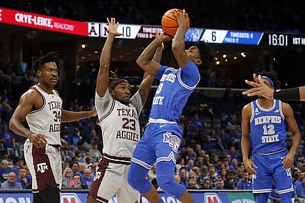 Dec 17, 2022; Memphis, Tennessee, USA; Memphis Tigers guard Kendric Davis (3) shoots as Texas A&M Aggies guard Tyrece Radford (23) defends during the first half at FedExForum. Mandatory Credit: Petre Thomas-USA TODAY Sports
