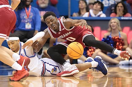 Indiana super-senior Xavier Johnson (0) trips on Kansas redshirt junior guard Dajuan Harris Jr. (3) during the first half of Saturday's game inside Allen Fieldhouse.

Syndication The Topeka Capital Journal
