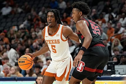 Dec 18, 2022; Dallas, Texas, USA;  Texas Longhorns guard Marcus Carr (5) controls the ball against Stanford Cardinal forward Harrison Ingram (55) during the first half at American Airlines Center. Mandatory Credit: Chris Jones-USA TODAY Sports