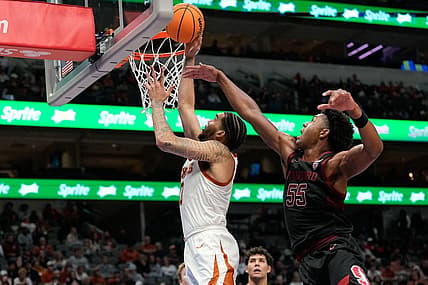Dec 18, 2022; Dallas, Texas, USA;  Texas Longhorns forward Timmy Allen (0) makes a layup past Stanford Cardinal forward Harrison Ingram (55) during the second half at American Airlines Center. Mandatory Credit: Chris Jones-USA TODAY Sports