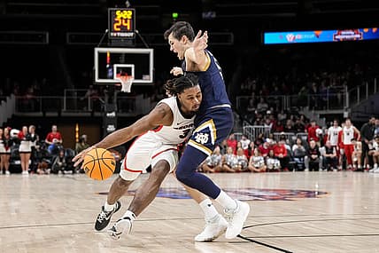 Dec 21, 2022; Athens, Georgia, USA; Georgia Bulldogs guard Kario Oquendo (3) dribbles against Notre Dame Fighting Irish guard Cormac Ryan (5) during the first half at State Farm Arena. Mandatory Credit: Dale Zanine-USA TODAY Sports