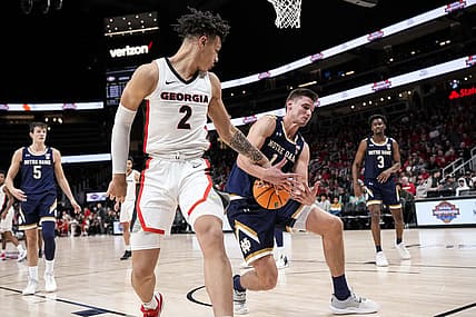 Dec 21, 2022; Athens, Georgia, USA; Georgia Bulldogs forward KyeRon Lindsay (2) and  Notre Dame Fighting Irish forward Nate Laszewski (14) battle for the ball during the first half at State Farm Arena. Mandatory Credit: Dale Zanine-USA TODAY Sports