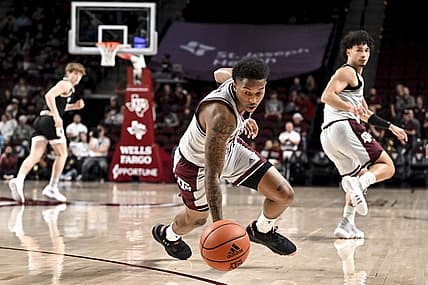 Dec 20, 2022; College Station, Texas, USA; Texas A&M Aggies guard Wade Taylor IV (4) lunges for a loose ball during the first half against the Wofford Terriers at Reed Arena. Mandatory Credit: Maria Lysaker-USA TODAY Sports