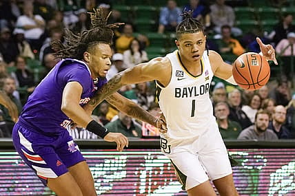Dec 20, 2022; Waco, Texas, USA; Baylor Bears guard Keyonte George (1) works around Northwestern State Demons guard Greedy Williams (10) during the second half at Ferrell Center. Mandatory Credit: Raymond Carlin III-USA TODAY Sports