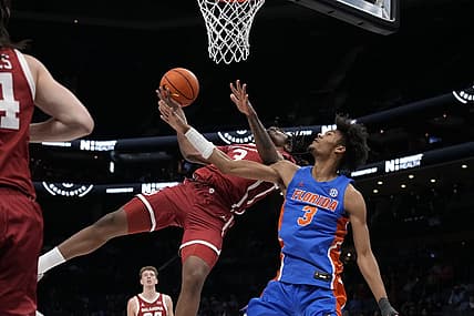 Dec 20, 2022; Charlotte, North Carolina, USA; Oklahoma Sooners guard Otega Oweh (3) gets fouled on his way to the basket by Florida Gators forward Alex Fudge (3) during the first half at the Jumpman Invitational  at the Spectrum Center. Mandatory Credit: Jim Dedmon-USA TODAY Sports