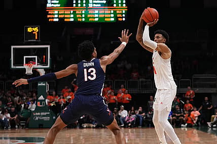 Dec 20, 2022; Coral Gables, Florida, USA; Miami Hurricanes guard Jordan Miller (11) shoots over Virginia Cavaliers guard Ryan Dunn (13) during the second half at Watsco Center. Mandatory Credit: Jasen Vinlove-USA TODAY Sports