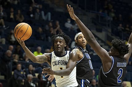 December 21, 2022; Berkeley, California, USA; California Golden Bears guard Joel Brown (1) shoots the basketball against Texas-Arlington Mavericks guard Aaron Cash (00) and forward Brandon Walker (2) during the first half at Haas Pavilion. Mandatory Credit: Kyle Terada-USA TODAY Sports