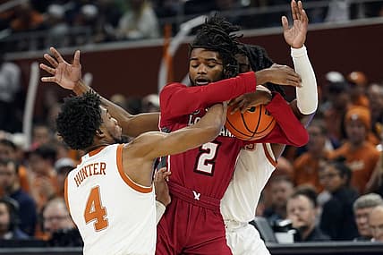 Dec 21, 2022; Austin, Texas, USA; Louisiana-Lafayette Ragin' Cajuns guard Michael Thomas (2) tries to keep the ball away from Texas Longhorns guards Tyrese Hunter (4) and Marcus Carr (5) during the first half at Moody Center. Mandatory Credit: Scott Wachter-USA TODAY Sports