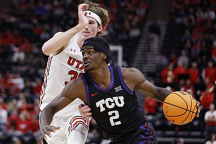 Dec 21, 2022; Salt Lake City, Utah, USA; TCU Horned Frogs forward Emanuel Miller (2) drives against Utah Utes center Branden Carlson (35) in the first half at Vivint Arena. Mandatory Credit: Jeffrey Swinger-USA TODAY Sports