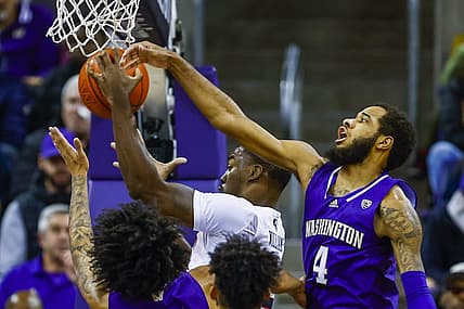 Dec 21, 2022; Seattle, Washington, USA; Auburn Tigers forward Jaylin Williams (2) collects an offensive rebound against Washington Huskies guard PJ Fuller II (4) during the first half at Alaska Airlines Arena at Hec Edmundson Pavilion. Mandatory Credit: Joe Nicholson-USA TODAY Sports