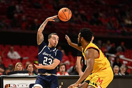 Dec 22, 2022; College Park, Maryland, USA;  St. Peter's Peacocks guard Alex Rivera (23) passes over his head passMaryland Terrapins forward Donta Scott (24) during the first half at Xfinity Center. Mandatory Credit: Tommy Gilligan-USA TODAY Sports
