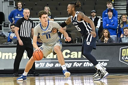 Dec 22, 2022; Omaha, Nebraska, USA; Creighton Bluejays center Ryan Kalkbrenner (11) backs in on Butler Bulldogs center Manny Bates (15) in the first half at CHI Health Center Omaha. Mandatory Credit: Steven Branscombe-USA TODAY Sports