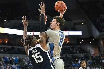 Dec 22, 2022; Omaha, Nebraska, USA;  Creighton Bluejays center Ryan Kalkbrenner (11) scores over Butler Bulldogs center Manny Bates (15) in the second half at CHI Health Center Omaha. Mandatory Credit: Steven Branscombe-USA TODAY Sports