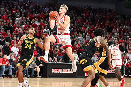 Dec 29, 2022; Lincoln, Nebraska, USA;  Nebraska Cornhuskers guard Sam Griesel (5) scores on a drive against Iowa Hawkeyes forward Kris Murray (24) in the first half at Pinnacle Bank Arena. Mandatory Credit: Steven Branscombe-USA TODAY Sports