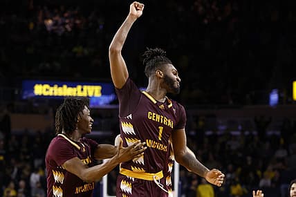 Dec 29, 2022; Ann Arbor, Michigan, USA;  Central Michigan Chippewas forward Ola Ajiboye (11) and guard Reggie Bass (1) celebrate after defeating the Michigan Wolverines at Crisler Center. Mandatory Credit: Rick Osentoski-USA TODAY Sports