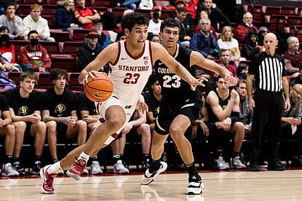 Dec 29, 2022; Stanford, California, USA; Stanford Cardinal forward Brandon Angel (23) drives past Colorado Buffaloes forward Tristan da Silva (23) during the first half at Maples Pavilion. Mandatory Credit: John Hefti-USA TODAY Sports