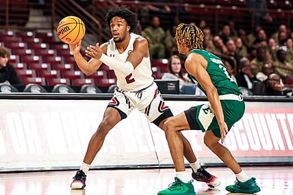 Dec 30, 2022; Columbia, South Carolina, USA; South Carolina Gamecocks guard Chico Carter Jr. (2) passes around Eastern Michigan Eagles guard Noah Farrakhan (2) in the first half at Colonial Life Arena. Mandatory Credit: Jeff Blake-USA TODAY Sports