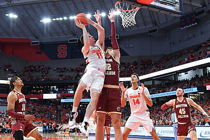 Dec 31, 2022; Syracuse, New York, USA; Syracuse Orange guard Joseph Girard III (11) shoots the ball as Boston College Eagles forward Quinten Post (12) defends during the first half at the JMA Wireless Dome. Mandatory Credit: Rich Barnes-USA TODAY Sports