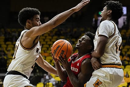 Dec 31, 2022; Laramie, Wyoming, USA; Wyoming Cowboys guard Noah Reynolds (21) and forward Caden Powell (44) trap New Mexico Lobos guard Jamal Mashburn Jr. (5) during the first half at Arena-Auditorium. Mandatory Credit: Troy Babbitt-USA TODAY Sports