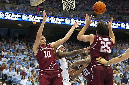 Nov 11, 2022; Chapel Hill, North Carolina, USA;  North Carolina Tar Heels forward Armando Bacot (5) battles for the ball against Charleston Cougars forward Ante Brzovic (10) and forward Ben Burnham (25) during the second half at Dean E. Smith Center. Mandatory Credit: James Guillory-USA TODAY Sports